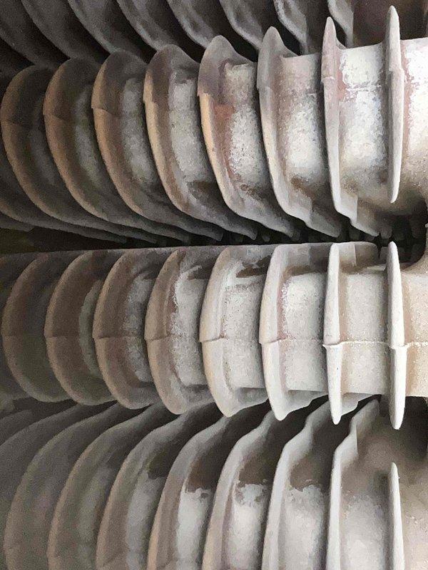 Performed comprehensive tune-up on 15-year-old boiler system, which was operating properly at time of service. Inspected gas burner assembly and combustion chamber, confirming proper flame characteristics with blue combustion pattern and adequate gas distribution through burner ports. Examined heat exchanger coils, noting dust and debris accumulation on spiral fin surfaces; cleaned heat exchanger sections to restore optimal heat transfer efficiency. Verified combustion chamber integrity, including insulation condition and panel seating. Additionally inspected radiant heating system in garage as requested, confirming proper operation of radiant heat components and distribution lines.