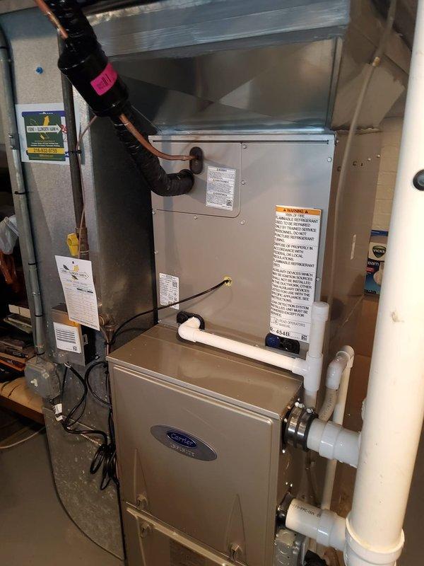 Completed installation of new air conditioning system including evaporator coil, refrigerant line set, and dedicated electrical circuit. Mounted Carrier air handler above existing furnace, established proper refrigerant connections with insulated line set, installed condensate drainage system with PVC piping, and ran new electrical service from main panel with appropriately sized breaker and disconnect. System tested and verified operational.