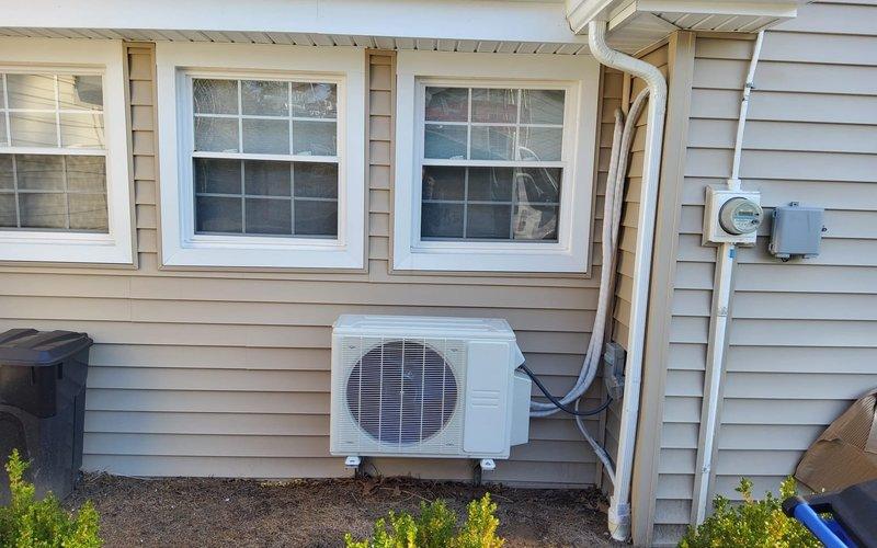 Responded to service call for 2-3 year old mini split system that was shutting off after one second of operation with blinking dotted line error code displayed on indoor unit. Upon arrival, performed diagnostic evaluation of both indoor wall-mounted evaporator unit and outdoor condenser unit. Inspected electrical connections, refrigerant lines, and communication wiring between indoor and outdoor components. Troubleshot error code indication and identified system malfunction. Tested unit operation and verified proper functionality of mini split system upon completion of service. Documented equipment condition with photographs of outdoor condenser unit mounted on exterior wall and indoor air handler installed above interior French door.