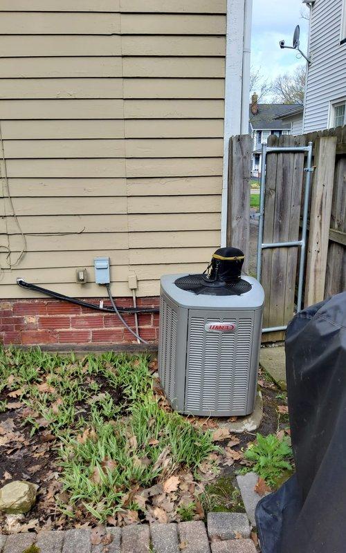 Completed routine maintenance inspection on residential Lennox air conditioning condenser unit. Performed visual assessment of equipment condition, verified proper installation of refrigerant lines and mounting hardware, and documented unit status with photographs. System observed to be properly positioned on level surface with adequate clearance from structure and fencing for airflow and future serviceability.