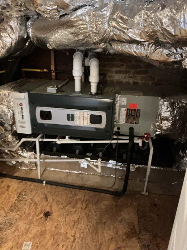 Completed HVAC system replacement estimate and documentation for residential property. Installation includes new horizontal air handler unit mounted in attic space with proper condensate drainage system featuring dual white PVC drain lines, electrical disconnect with safety shutoff, and reflective insulation barriers. Basement mechanical room houses new furnace unit with gray metal cabinet, dual white PVC intake and exhaust venting system, insulated ductwork distribution, and coordinating water heater installation. All equipment properly positioned on OSB decking in attic and concrete flooring in basement with appropriate clearances for service access. Documented complete installation with photographic evidence showing proper mounting, drainage configuration, electrical connections, and ventilation components meeting code requirements.