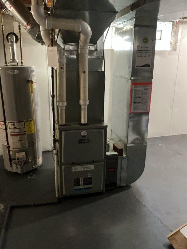 Completed HVAC system replacement estimate and documentation for residential property. Installation includes new horizontal air handler unit mounted in attic space with proper condensate drainage system featuring dual white PVC drain lines, electrical disconnect with safety shutoff, and reflective insulation barriers. Basement mechanical room houses new furnace unit with gray metal cabinet, dual white PVC intake and exhaust venting system, insulated ductwork distribution, and coordinating water heater installation. All equipment properly positioned on OSB decking in attic and concrete flooring in basement with appropriate clearances for service access. Documented complete installation with photographic evidence showing proper mounting, drainage configuration, electrical connections, and ventilation components meeting code requirements.