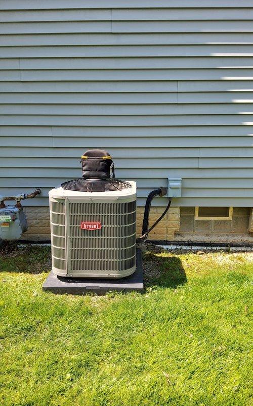 Performed routine maintenance inspection on residential air conditioning system. Unit was accessed on side of house, with outdoor condenser positioned on concrete pad in good condition. Connected manifold gauges to verify refrigerant pressures and system performance. All refrigerant lines showed proper insulation with no visible damage or wear. Condenser coils were clean with adequate airflow through vertical fins. Fan guard and motor assembly operating normally. System tested under fair weather conditions at 59°F ambient temperature, confirming proper operation ahead of cooling season. No repairs required at this time.