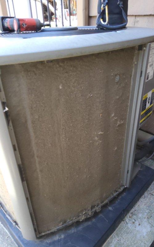 Completed comprehensive tune-up on outdoor air conditioning unit over 10 years old. Performed standard maintenance protocol including inspection of all major components, cleaning of heavily soiled condenser coil and filter screen which showed significant dust and debris accumulation, verification of refrigerant levels, electrical connection testing, and operational assessment. Unit returned to proper working condition with improved airflow efficiency following removal of substantial particulate buildup from intake surfaces.