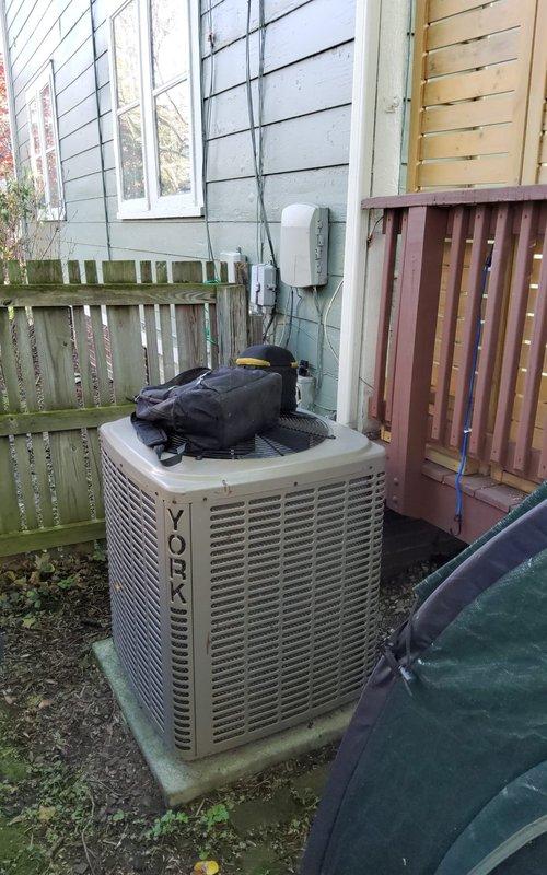 Completed scheduled preventive maintenance on York model YCJF30S41S1A outdoor condensing unit utilizing R-410A refrigerant. Performed comprehensive cooling system inspection, verified electrical connections and voltage specifications at 208-230V single-phase, confirmed proper refrigerant charge levels using subcooling method per manufacturer specifications, inspected condenser coil condition, and documented unit nameplate data including serial number W1D2717349. All components operating within normal parameters upon completion of maintenance service.