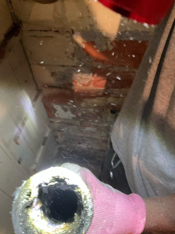 Completed partial stack replacement in plumbing system. Removed deteriorated stack section showing significant corrosion, dark staining, and residue buildup on piping components. Toilet was temporarily removed to access work area and will be reinstalled upon completion of stack installation. Work area showed evidence of water damage and material deterioration requiring intervention.