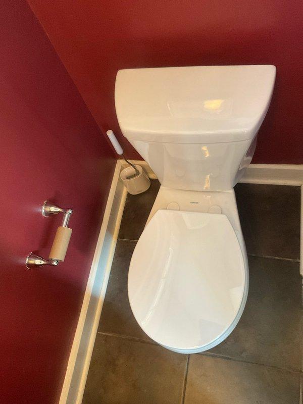 Removed existing toilet from bathroom and prepared flange area for new installation. Installed Gerber Avalanche elongated toilet with new wax seal and supply line, ensuring proper alignment and secure mounting to floor flange. Completed installation with new toilet seat and verified proper flush operation and water supply connection.