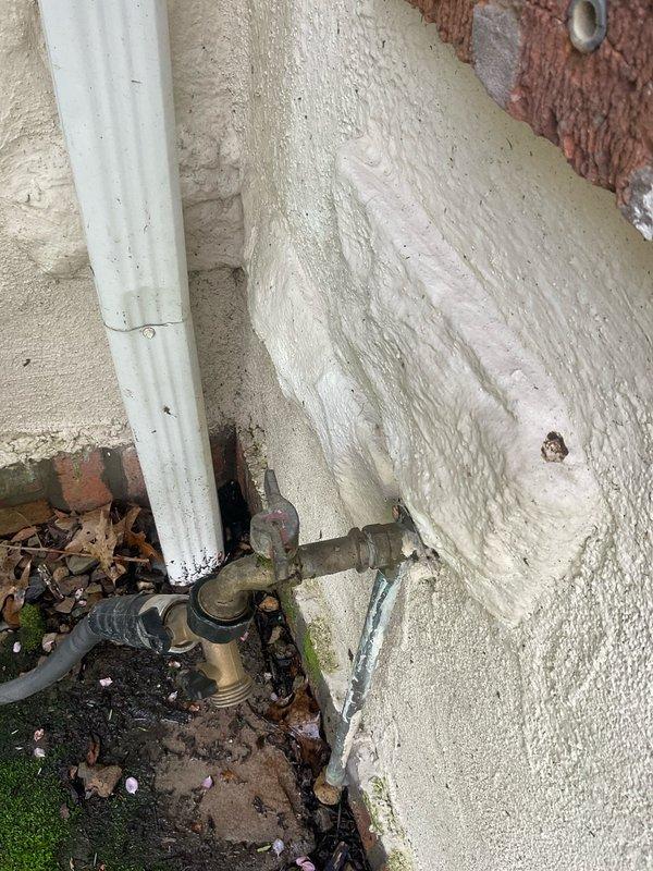 Responded to service call for possible gas line connection issue to outdoor gas grill at century-old residential property. Upon arrival, conducted thorough visual inspection of exterior gas piping system and connections. Located gas supply line running along exterior wall with visible aged brass fittings and weathered piping showing signs of corrosion and environmental exposure. Performed comprehensive gas leak detection testing at all connection points, joints, and fittings using leak detection solution. Inspected gas line routing from building to grill connection point, noting deteriorated condition of exterior plumbing infrastructure consistent with age of home. Verified gas pressure at supply line and tested system integrity. Documented existing conditions of gas piping assembly, fittings, and connection points with photographs for service records. All testing completed to ensure safe gas delivery to outdoor appliance connection.