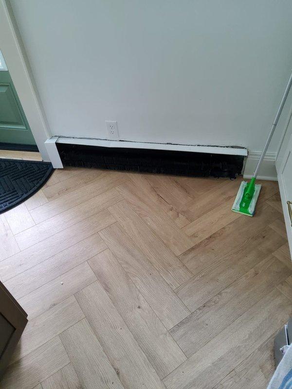 Responded to callback for radiator heating issues in kitchen area. Upon inspection, found main radiator packing nut leaking when valve was opened. Attempted to tighten packing nut but access was blocked by recently installed renovation wall, preventing proper repair. Documented conditions with photos showing affected radiator locations and obstruction preventing full service completion.