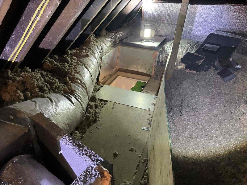 # HVAC System Replacement - Dual Unico Mini Split Installation

Completed replacement of two Unico system units serving the east wing and west wing of the residence. Accessed attic space using 8-foot frame ladder to remove existing air handler equipment and associated ductwork. Installed new beige air handler units in attic, positioning them on insulated attic floor among existing rafters and maintaining proper clearances from flexible ductwork runs.

Exterior work included installation of two Luxaire outdoor condensing units positioned side by side on stone facade wall. Units were mounted on river rock bed with appropriate spacing for service access and airflow. Ran electrical conduit and refrigerant line sets between outdoor units and attic-mounted air handlers, securing all connections per manufacturer specifications. Completed electrical connections with junction boxes mounted to exterior wall between units.

System tested and confirmed operational for both east and west wing zones