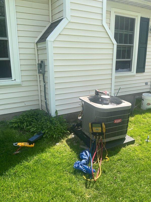 Completed spring air conditioning maintenance on Bryant condensing unit installed approximately 2020. Performed comprehensive system tune-up including refrigerant pressure and temperature diagnostics using digital manifold gauge, which confirmed proper operating pressures of 122.1 PSI low side and 297.2 PSI high side with corresponding temperatures of 138°F and 123°F. Inspected condenser coil, electrical connections, and refrigerant lines; system operating within manufacturer specifications with no deficiencies noted.