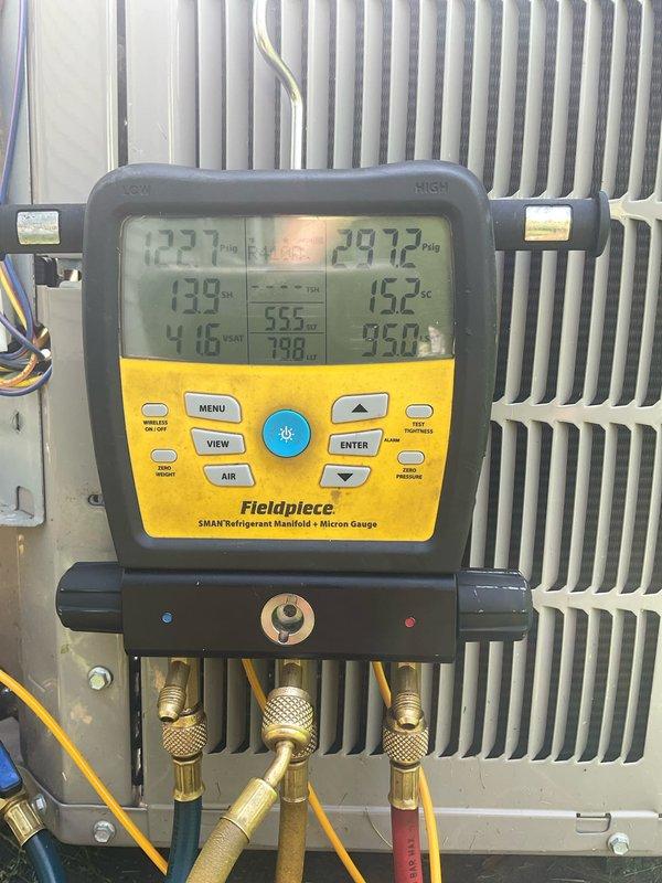 Completed spring air conditioning maintenance on Bryant condensing unit installed approximately 2020. Performed comprehensive system tune-up including refrigerant pressure and temperature diagnostics using digital manifold gauge, which confirmed proper operating pressures of 122.1 PSI low side and 297.2 PSI high side with corresponding temperatures of 138°F and 123°F. Inspected condenser coil, electrical connections, and refrigerant lines; system operating within manufacturer specifications with no deficiencies noted.