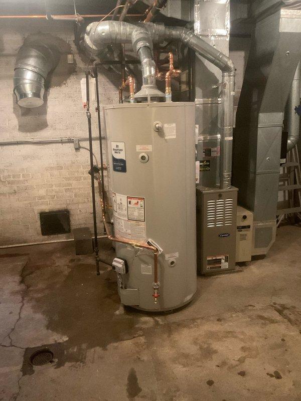 Installed a 100-gallon water heater alongside existing unit to ensure continuous hot water availability during the transition. Installed two 1-inch isolation valves to enable independent shutdown of either tank while maintaining hot water flow to the building. Completed all copper piping connections between units, integrated gas line with shut-off valve, and verified proper operation of both water heating systems in the basement mechanical room.