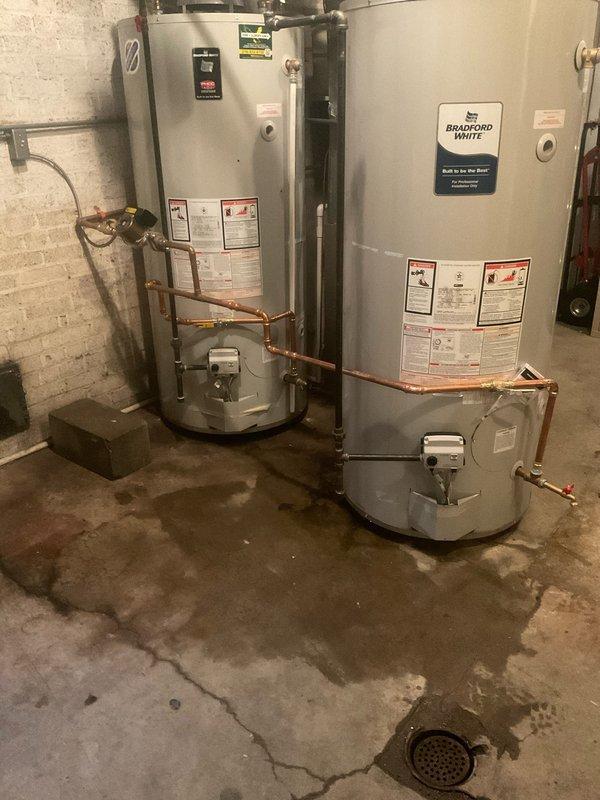 Installed a 100-gallon water heater alongside existing unit to ensure continuous hot water availability during the transition. Installed two 1-inch isolation valves to enable independent shutdown of either tank while maintaining hot water flow to the building. Completed all copper piping connections between units, integrated gas line with shut-off valve, and verified proper operation of both water heating systems in the basement mechanical room.