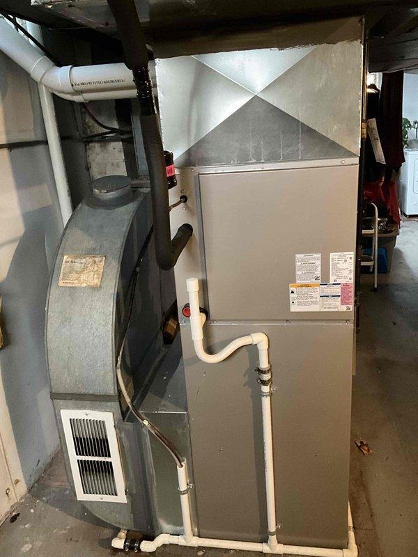 Conducted comprehensive evaluation of 6-year-old HVAC system experiencing ice damage to air handler unit. Assessed extent of damage to evaporator coil, refrigerant lines, and associated components in basement mechanical room. Documented current equipment condition including furnace, air handler with PVC condensate drainage system, and ductwork configuration. Photographed installation showing gray metal ductwork, white PVC venting, and existing system layout for estimate preparation. Provided detailed analysis comparing repair costs versus full system replacement options, taking into account age of equipment, severity of ice damage, and long-term reliability considerations. Recommended replacement due to extent of damage and equipment age approaching mid-life point where major component failures become increasingly common.