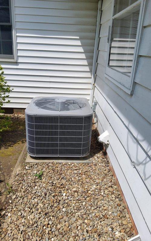Completed annual maintenance on 12-year-old residential air conditioning system. Performed comprehensive tune-up including inspection of indoor furnace unit and outdoor condensing unit, verified proper operation of all components, and documented equipment condition with photographs showing both basement mechanical room and exterior AC unit in satisfactory working order.