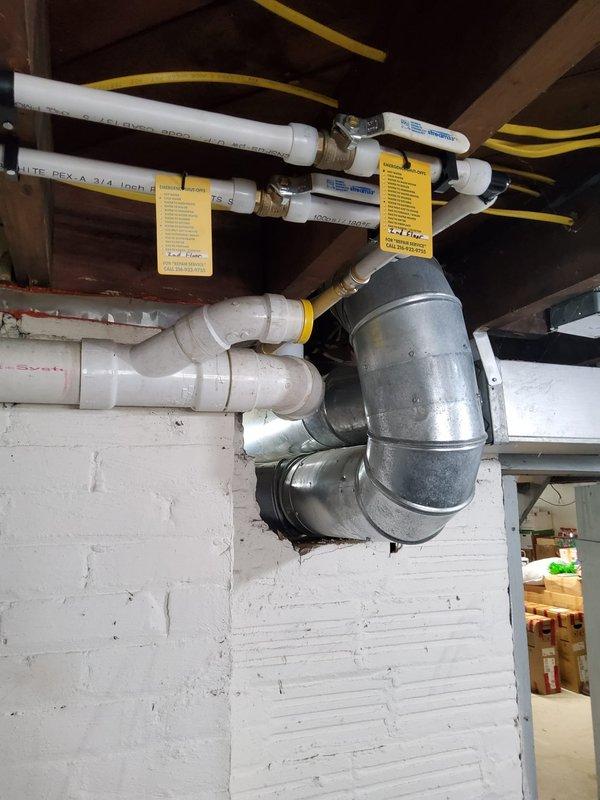 Completed full-day water heater replacement and repiping project in residential basement utility area. Removed existing water heater and installed new 50-gallon tall residential gas-fired unit with proper venting configuration. Replaced exposed CPVC water distribution lines with new white PEX piping throughout the service area, connecting to existing CPVC risers using SharkBite push-to-connect fittings for secure transitions. Installed pressure regulator at water meter to protect plumbing system and ensure proper operating pressure. All pipe connections tested and verified leak-free. Installation completed to code with proper support and routing of supply lines along ceiling joists. System commissioned and operational upon completion.