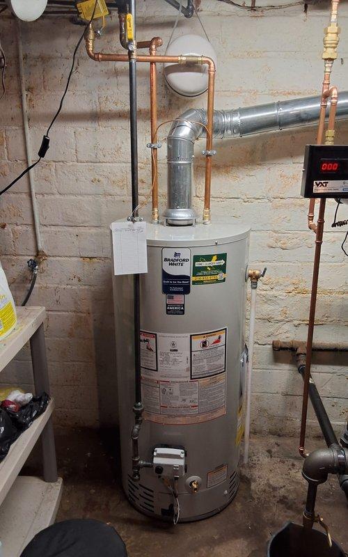 Completed full steam boiler replacement, installing a New Yorker model CGS50C steam gas boiler with all required safety and control components. Installation included new automatic water feeder, low water cutoff, sight glass, pressure control, and programmable thermostat for improved system efficiency and monitoring. All near boiler piping was modified to meet current code requirements, and a new backflow preventer was installed to protect the potable water supply. Additionally, replaced the existing water heater with a Bradford White 40-gallon residential unit, complete with proper venting and copper supply line connections. Both units were tested, verified for proper operation, and left in full working condition.