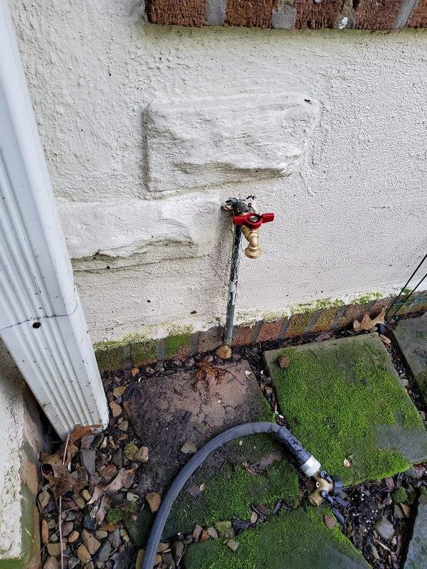 Replaced aged and heavily corroded exterior hose bibb with a new long shank boiler drain style spigot featuring a 1/2" connection. The installation was designed to position the connection away from the house exterior for improved accessibility and ease of use. The existing plumbing showed significant oxidation and weathering, requiring removal of the deteriorated fixture and proper installation of the upgraded assembly to ensure reliable water delivery and prevent future leakage issues.