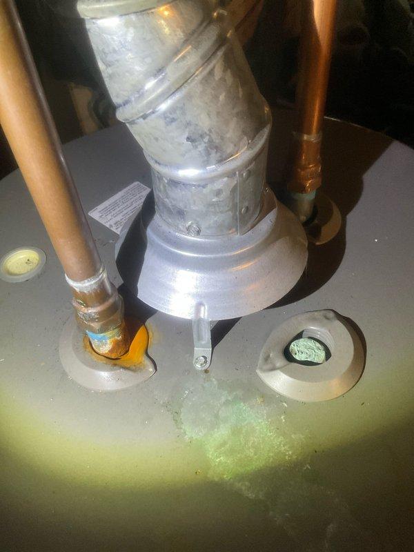 Responded to no hot water complaint on Rheem Performance tanked water heater. Upon arrival, conducted visual inspection of unit and surrounding area. Noted water staining on concrete floor around base of tank indicating possible leak or discharge from temperature and pressure relief valve. Inspected top connections including copper supply lines, pressure relief valve with discharge tube, and exhaust venting.

Removed access cover to inspect internal tank condition. Found significant sediment accumulation on tank floor consisting of mineral deposits, indicating extended period without maintenance flushing. Examined anode rod port, flue baffle assembly, and dip tube connection. Central flue pipe showed discoloration and wear consistent with combustion byproduct exposure. Mineral buildup was restricting proper water circulation and likely contributing to heating inefficiency and premature element or burner failure.

Documented existing conditions with photographs showing external unit con