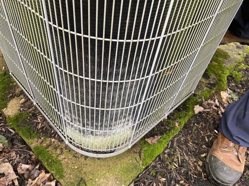 Completed comprehensive cooling maintenance tune-up on three residential air conditioning systems of varying ages (10+ years and 2+ years old) as part of recurring home plan service. Performed standard 8-12 point maintenance protocol on all units including refrigerant pressure testing, temperature differential measurements, and visual equipment inspections.

Conducted thorough examination of outdoor condenser units, measuring system performance with calibrated digital thermometer showing temperature readings within operational parameters. Inspected condenser coil grilles and housings, noting accumulated dirt, debris, and environmental weathering consistent with outdoor exposure and system age. Documented equipment condition with service photographs showing typical wear patterns and surface discoloration on older units.

Assessed installation pads and surrounding areas, observing moss and algae growth on concrete surfaces indicating adequate drainage but extended moisture exposure. Clea