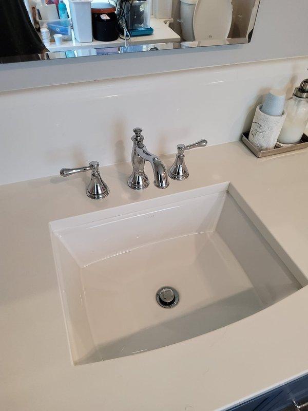 Responded to service call for three leaking faucets and slow drain issue in century-old residential property. Inspected and serviced chrome three-piece faucet assemblies at bathroom vanity with undermount sink, first-floor powder room with wall-mounted porcelain sink, and basement location. Addressed leak sources by replacing worn washers and seals in traditional compression-style faucet handles. Cleared slow-draining bathroom sink by removing debris accumulation from pop-up drain assembly and P-trap. All fixtures tested for proper operation and verified leak-free performance upon completion.