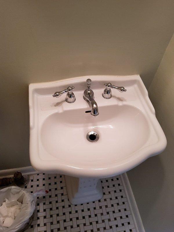 Responded to service call for three leaking faucets and slow drain issue in century-old residential property. Inspected and serviced chrome three-piece faucet assemblies at bathroom vanity with undermount sink, first-floor powder room with wall-mounted porcelain sink, and basement location. Addressed leak sources by replacing worn washers and seals in traditional compression-style faucet handles. Cleared slow-draining bathroom sink by removing debris accumulation from pop-up drain assembly and P-trap. All fixtures tested for proper operation and verified leak-free performance upon completion.