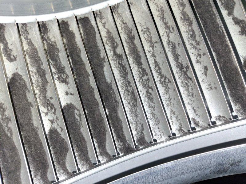 # HVAC Cooling System Maintenance Completed

Performed comprehensive preventive maintenance on a single cooling system unit. Upon arrival, conducted visual inspection of the outdoor condenser unit, which revealed significant accumulation of dust, dirt, and debris on the condenser coil fins. The contamination was distributed unevenly across the fin surfaces, with heavy buildup in multiple areas that restricted proper airflow and heat transfer efficiency.

Cleaned the condenser coil thoroughly, removing accumulated dirt, lint, and airborne particles from the aluminum fins and between fin spaces. Restored optimal spacing and airflow capacity through the heat exchanger component. Following cleaning procedures, utilized Fieldpiece digital diagnostic equipment to measure and verify system operating parameters. Connected refrigeration gauges to service ports and recorded temperature and pressure readings across the system to confirm proper refrigerant charge levels and overall system performa
