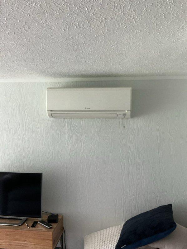 Conducted estimate for mini-split system replacement in residential property. Evaluated existing Mitsubishi Electric air handler unit installed in attic space with connected flexible ductwork and PVC condensate drainage, along with wall-mounted indoor unit in bedroom. Documented current system configuration and captured photos of equipment for proposal preparation.