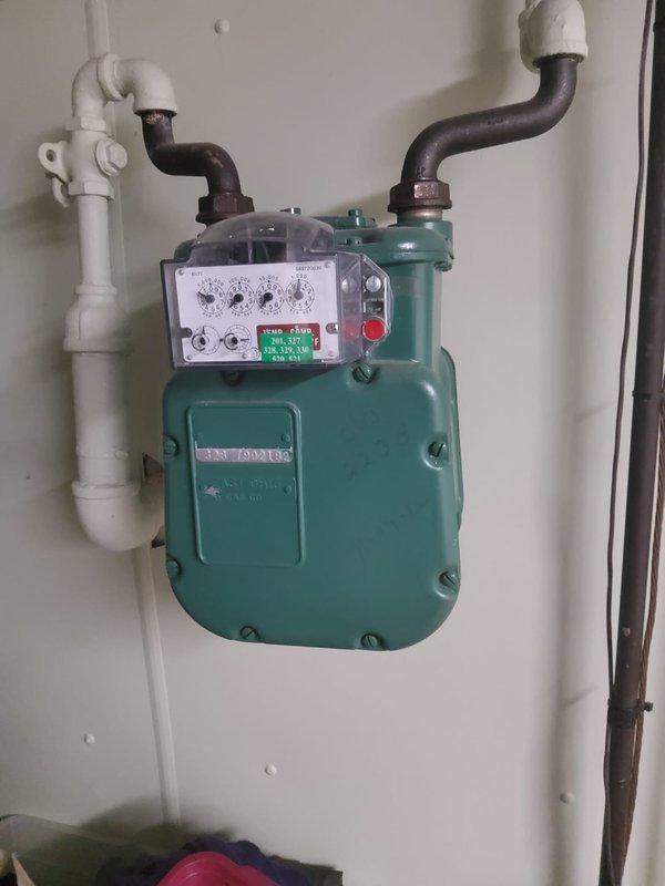 Provided on-site assessment and quote for exterior gas line installation. Inspected existing gas meter and associated piping infrastructure, including connections to main supply lines. Evaluated current configuration of gas delivery system, noting teal utility meter with mechanical display dials mounted to exterior wall with PVC and metal pipe connections. Assessed condition of existing copper and metal piping showing age-related oxidation and corrosion. Documented installation site conditions and pipe routing requirements for proposed gas line extension work.