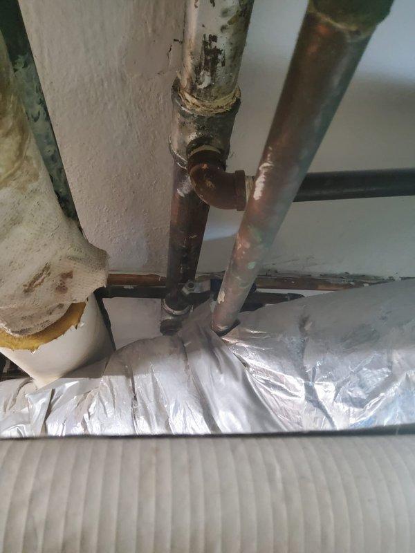 Provided on-site assessment and quote for exterior gas line installation. Inspected existing gas meter and associated piping infrastructure, including connections to main supply lines. Evaluated current configuration of gas delivery system, noting teal utility meter with mechanical display dials mounted to exterior wall with PVC and metal pipe connections. Assessed condition of existing copper and metal piping showing age-related oxidation and corrosion. Documented installation site conditions and pipe routing requirements for proposed gas line extension work.