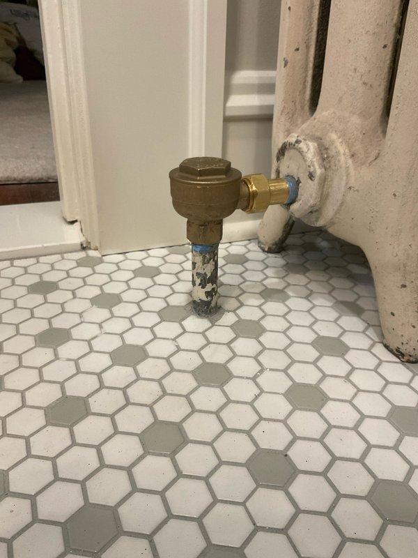 Completed removal and capping of two deteriorated radiators in residential property. Collected deposit payment and coordinated with appropriate departments for sold repair estimate processing. Documentation and photos captured showing existing conditions of heavily corroded radiator units with extensive paint failure and brass shut-off valves requiring decommissioning.