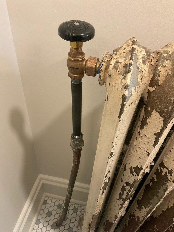 Completed removal and capping of two deteriorated radiators in residential property. Collected deposit payment and coordinated with appropriate departments for sold repair estimate processing. Documentation and photos captured showing existing conditions of heavily corroded radiator units with extensive paint failure and brass shut-off valves requiring decommissioning.