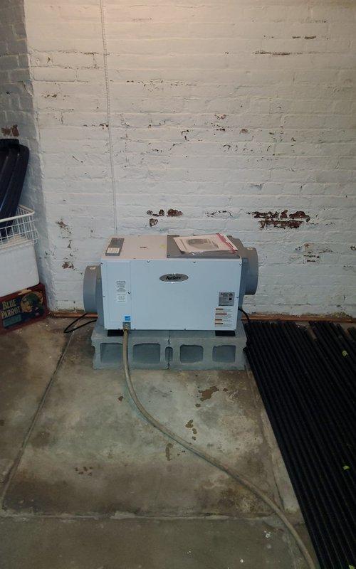 Responded to service call for hot water tank leak inspection and blank thermostat issue. Upon arrival, conducted thorough assessment of plumbing system beneath bathroom vanity, inspecting P-trap assembly and supply lines for signs of moisture or active leaking. Examined HVAC equipment in mechanical room, including light blue condensate pump unit mounted on support brackets with associated drainage hoses and ductwork connections. Verified thermostat functionality and power supply to heating system. Documented existing conditions with photographs for customer records and further evaluation of potential water heater concerns.