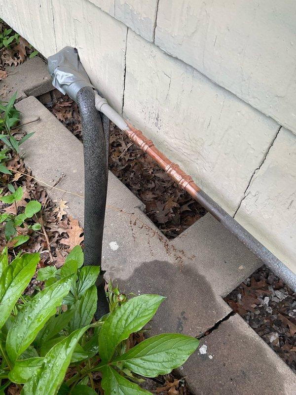 Responded to service call for multiple water leaks throughout the property. Repaired leaking outside spigot at exterior foundation, replaced faulty hot water shut-off valve under kitchen sink, and addressed leaking waterline connection at bathroom sink. Photographic documentation revealed corroded pipe fittings with visible rust staining and water damage at appliance base, indicating prolonged moisture exposure. Exterior inspection showed insulated pipes along foundation with exposed copper section requiring attention. All leak sources were identified, connections were secured or replaced as needed, and water flow was restored to proper operating condition.