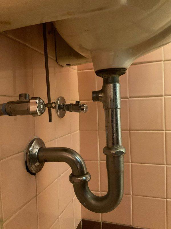 Completed new sink installation in compact powder room. Installed white porcelain sink with chrome P-trap assembly and connected drain line to existing wall outlet. Installed supply line with shut-off valve and verified all connections for proper sealing and operation. All plumbing fixtures tested and confirmed leak-free upon completion.