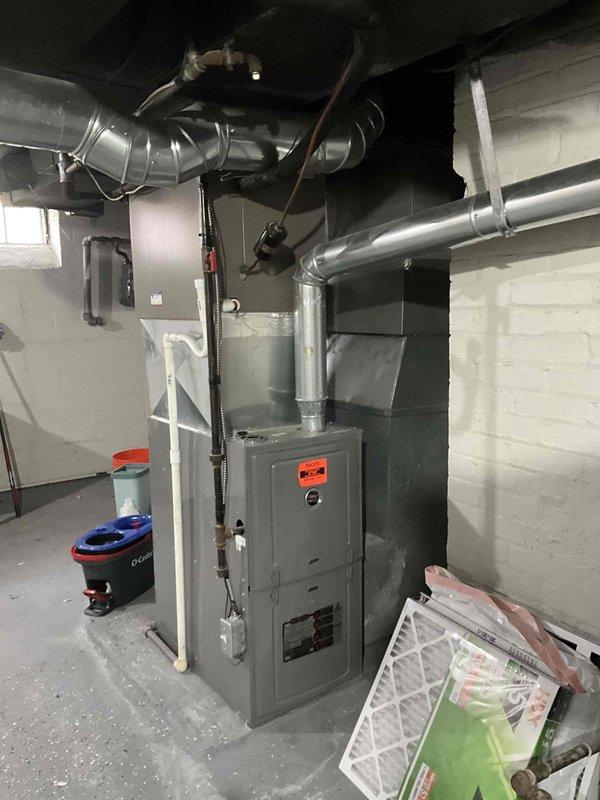 Conducted on-site evaluation for complete HVAC system replacement at residential property with 26-year-old existing equipment. Assessed current basement-mounted furnace installation with associated ductwork configuration and outdoor condensing unit positioned on concrete pad against exterior foundation. Documented existing system components, mechanical room layout, and outdoor unit placement for replacement specifications and equipment sizing recommendations.