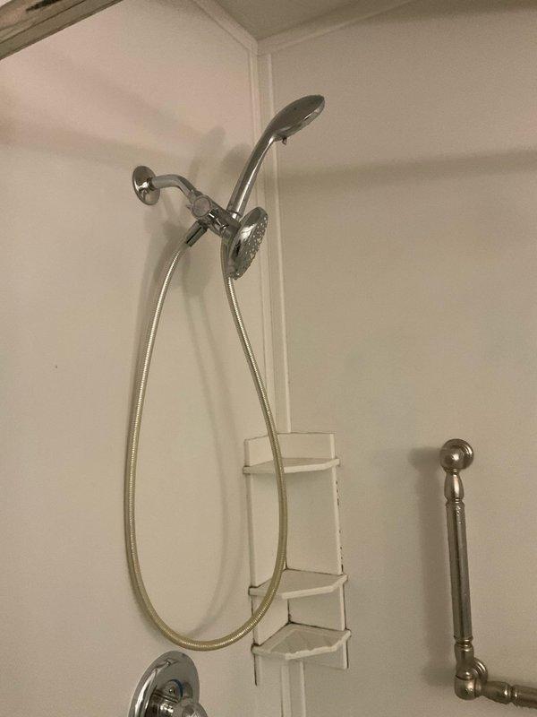 Installed a Moen Posi-Temp pressure-balancing valve and trim kit in brushed nickel finish for shower-only application. Opened and repaired a section of drywall to access existing copper supply lines for proper valve installation. Completed full installation with all components tested and operational.