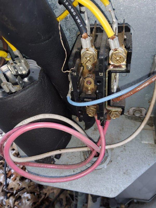 # HVAC Maintenance - Cooling System Service

Performed comprehensive AC tune-up on residential cooling system utilizing R22 refrigerant. Connected Testo 550 digital manifold gauges to measure system pressures and temperatures, recording suction pressure of 42.5 psi and discharge pressure of 270 psi with temperatures reading 48.6°F and 50.3°F. Inspected outdoor condensing unit including condenser coil condition through protective mesh guard, verified unit was mounted properly on concrete pad.

Examined electrical connections at terminal block, noting multiple wire connections including yellow/black striped, blue, pink/red, and white wires properly secured to brass screw terminals with appropriate crimped connectors. Observed typical dust and debris accumulation on electrical components and mounting surfaces consistent with system age and operation. Inspected capacitor and associated wiring configuration for proper connections and secure mounting.

System currently operating within norma