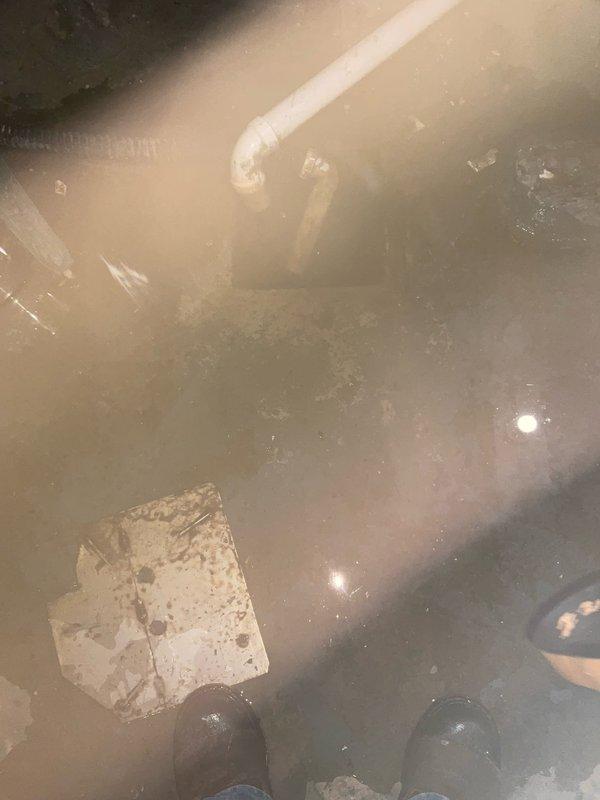 Responded to a water heater leak originating from the outlet connection on a previously installed tanked unit. Upon arrival, identified active water discharge from the hot water outlet fitting causing floor saturation in the installation area. Performed pressure testing using diagnostic gauge to verify system pressure and identify the source of the leak at the outlet connection. Addressed the faulty outlet fitting, secured all connections, and verified proper seal integrity. Cleaned up standing water from the concrete floor surface surrounding the unit. Conducted final pressure test to confirm leak resolution and proper system operation before restoring unit to service.