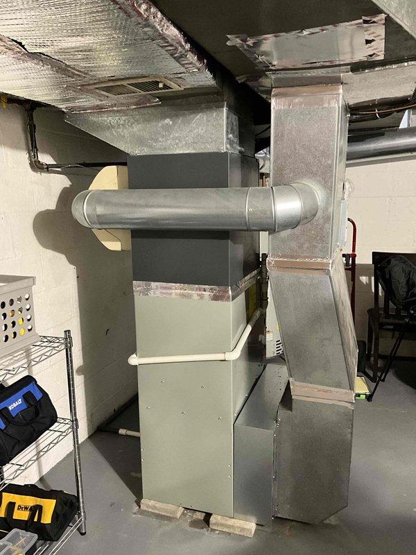 Conducted on-site assessment for HVAC system replacement. Documented existing Goodman ASXE16030TF4 air handler unit specifications, including electrical ratings of 208-230V and relevant model information for replacement planning. Evaluated current basement installation configuration, including existing ductwork connections, supply plenums, and insulated refrigerant lines. Photographed equipment labels and mechanical room layout to provide comprehensive documentation for preparing replacement estimate and ensuring proper equipment sizing for the application.