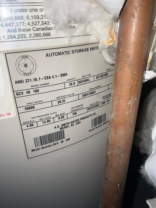 Responded to call regarding water heater backdrafting and gas odor occurring when AC system activates. Inspected A.O. Smith 40-gallon natural gas water heater (Model GCV 40 100, 40,000 BTU input) and shared venting system with HVAC equipment. Evaluated chimney draft conditions, venting configuration, and combustion air supply to diagnose backdrafting issue caused by negative pressure when air conditioning system operates. Documented existing installation conditions including spray foam insulation on tank, copper supply piping, and shared flue arrangement with photographic evidence for further assessment and recommended corrective actions to resolve unsafe venting condition.