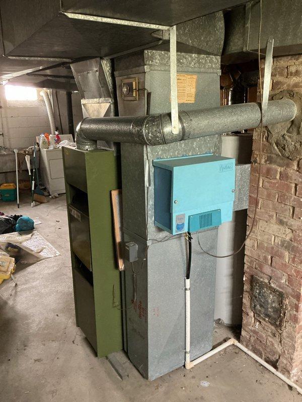 Provided complete HVAC system replacement estimate for existing furnace and air conditioning equipment located in basement utility area. Discussed financing options and noted pricing updates from previous year's quote, documented existing green furnace unit with air purification system and electrical panel capacity for new equipment installation.