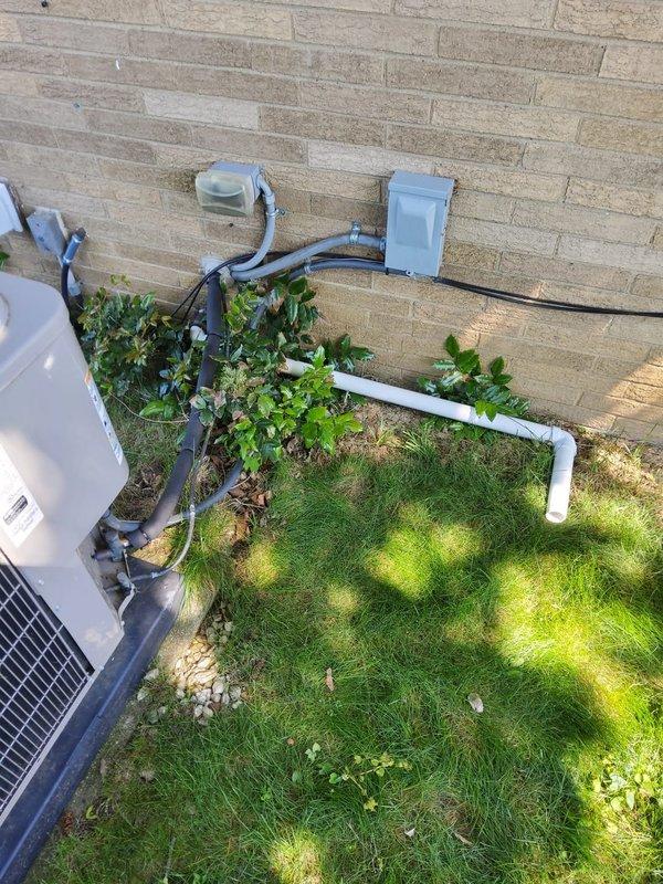 Completed installation of sump pump discharge extension with grille assembly for EZ Breathe system, including proper insulation using Armaflex material on exposed piping. Verified system operation and tested refrigerant pressures on R410A air conditioning unit, confirming temperatures of 49.7°F on suction line and 66.7°F on liquid line with appropriate system pressures.