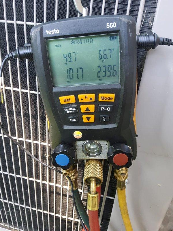 Completed installation of sump pump discharge extension with grille assembly for EZ Breathe system, including proper insulation using Armaflex material on exposed piping. Verified system operation and tested refrigerant pressures on R410A air conditioning unit, confirming temperatures of 49.7°F on suction line and 66.7°F on liquid line with appropriate system pressures.