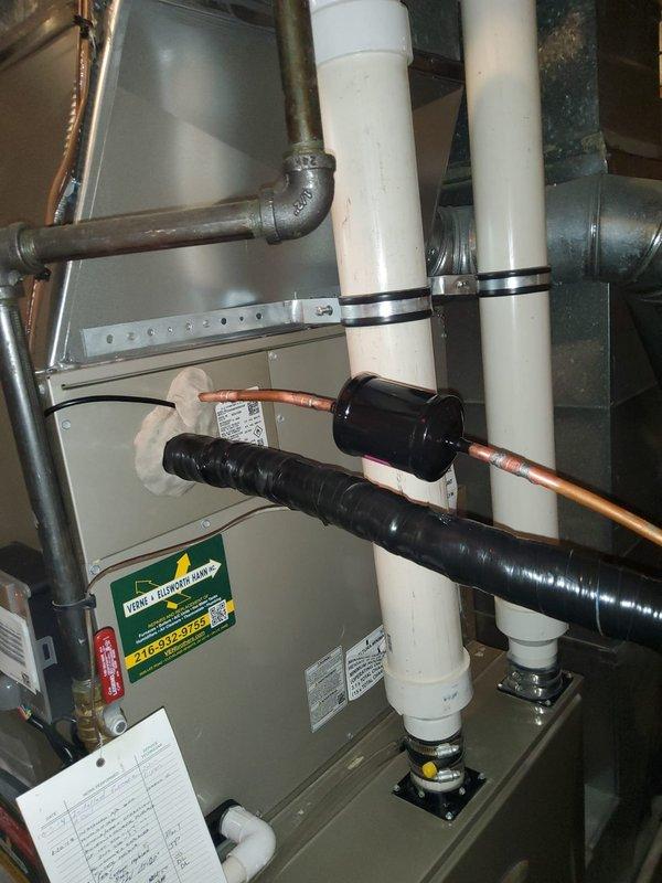 Completed full HVAC system replacement including outdoor condensing unit and indoor evaporator coil. Existing refrigerant line set was inspected, pressure tested, and reused to minimize installation time and cost. New condenser unit was positioned on existing concrete pad with proper clearances maintained. Indoor evaporator coil was installed above furnace/air handler in basement mechanical room, integrated with existing ductwork system. All refrigerant lines were properly connected and insulated. System was evacuated to manufacturer specifications, charged with appropriate refrigerant type and quantity per equipment requirements. Electrical connections were completed at both indoor and outdoor units with proper disconnect switches verified. Condensate drain system was connected and tested for proper operation. System startup performed with all operating pressures and temperatures verified within normal parameters. Airflow across coil confirmed adequate. Unit cycled through complete co