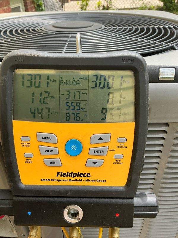Completed comprehensive air conditioning tune-up on residential cooling system approximately five years old. System diagnostics performed using refrigerant manifold gauges, with pressure and temperature readings confirming proper refrigerant charge levels. Significant accumulation of dust and debris was identified on the blower wheel assembly, which was thoroughly cleaned to restore optimal airflow and system efficiency.