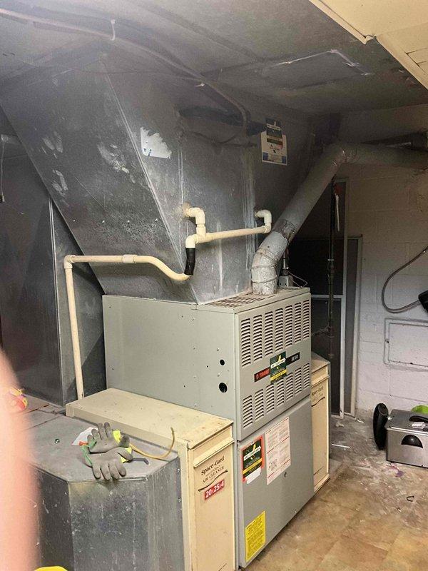 Performed comprehensive estimate for HVAC system replacement on residential property with 1990s-era furnace that remains operational. Evaluated existing indoor furnace unit located in basement and outdoor condensing units positioned at building exterior, documented current equipment condition and configuration, and provided homeowner with replacement options for aging but functional heating and cooling system.
