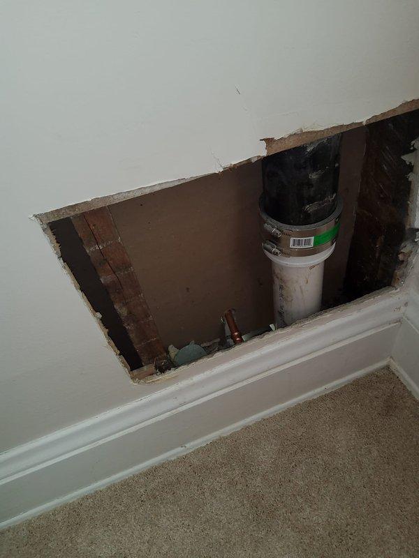 Responded to emergency plumbing issue in second-floor full bathroom where improper drainage installation caused significant water accumulation in ceiling below. Identified double-trapped 1.5-inch PVC drain line connected to bathtub with improperly installed air admittance valve left open, creating drainage failure. Created access opening in ceiling below bathroom to expose and assess tub drain, lavatory drain, and toilet drainage systems. Recommended complete re-piping of all bathroom drainage fixtures to correct code violations and prevent further water damage.