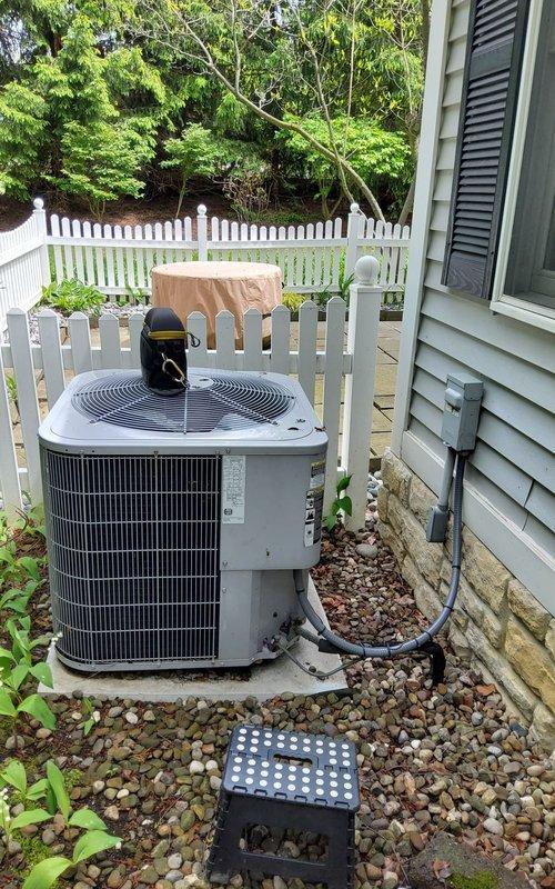 Completed comprehensive air conditioning tune-up on residential split system with outdoor condensing unit and indoor air handler. Performed full system inspection including visual assessment of both indoor and outdoor components, verified proper operation of condenser fan and compressor, checked refrigerant lines and electrical connections, and confirmed adequate airflow through evaporator coil. System found to be operating within normal parameters with no immediate service needs identified.